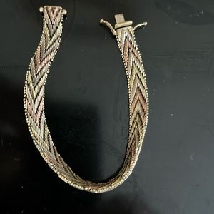 This is a gold, white gold, and rose gold 14k bracelet.